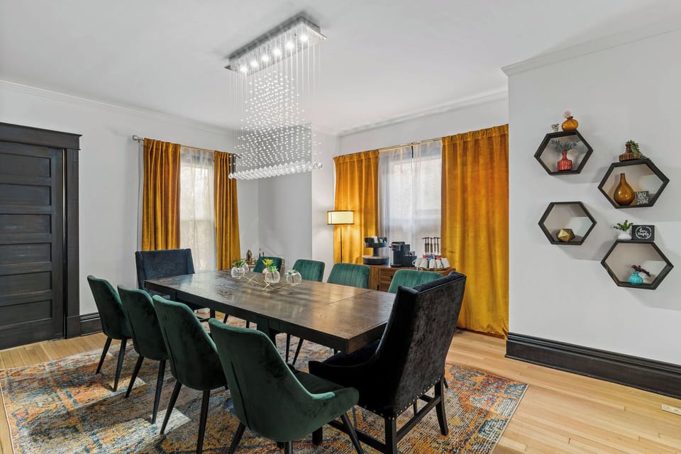 First-Floor Dining Room with seating for the whole group and a stunning modern chandelier—perfect for gathering before walking to Westport and West 39th Street.