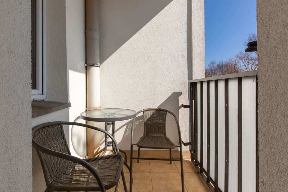 A small balcony with outdoor seating, providing a cozy spot to relax and enjoy the view.