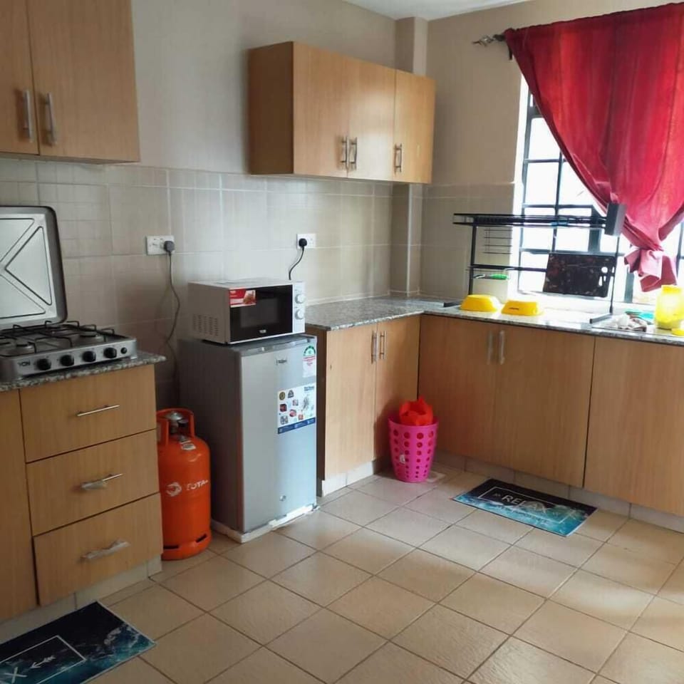 Comfort Apartment | Private kitchen | Fridge, microwave, cookware/dishes/utensils, dining tables
