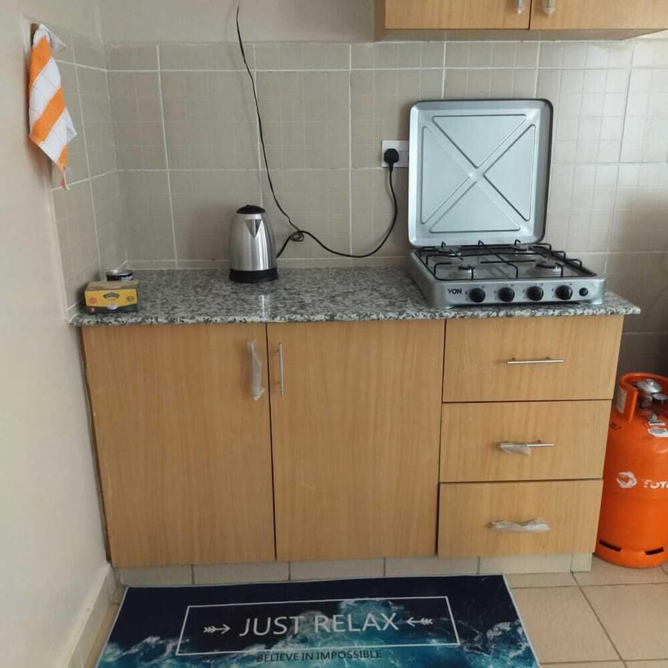 Comfort Apartment | Private kitchen | Fridge, microwave, cookware/dishes/utensils, dining tables