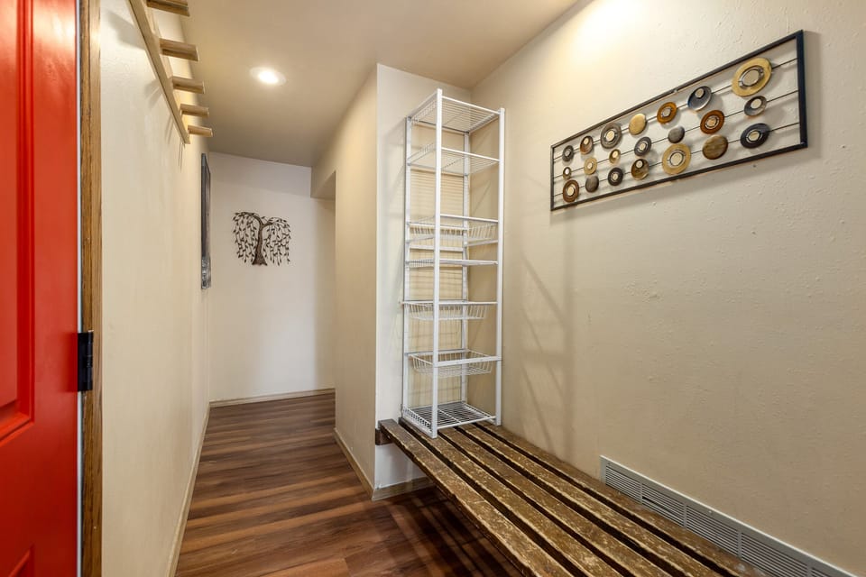 Step into your organized storage area with convenient shelving and artistic touches that make staying organized feel effortless.