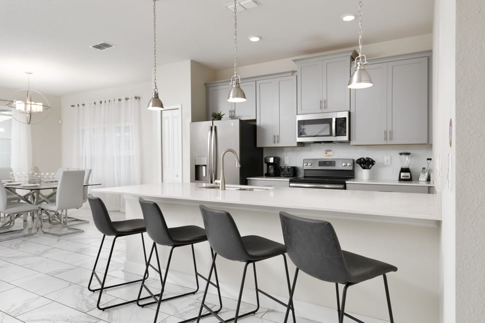 Modern kitchen with updated stainless steel appliances for cooking.