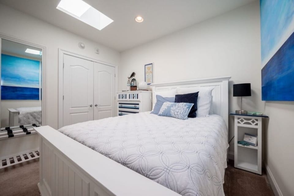 Natural light second bedroom with queen bed with memory foam mattress.