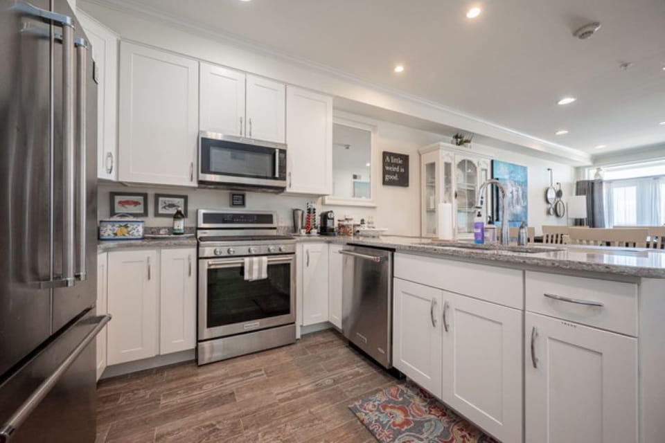 Stainless steel appliances and fully stocked kitchen.
