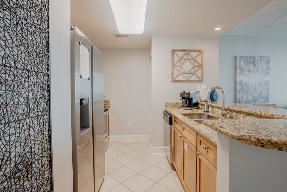 Kitchen island with sink and dishwasher, opening directly into the living area.