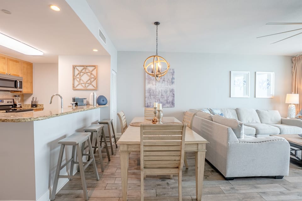 Kitchen and bar seating flowing into the living area, great for gathering and cooking together.