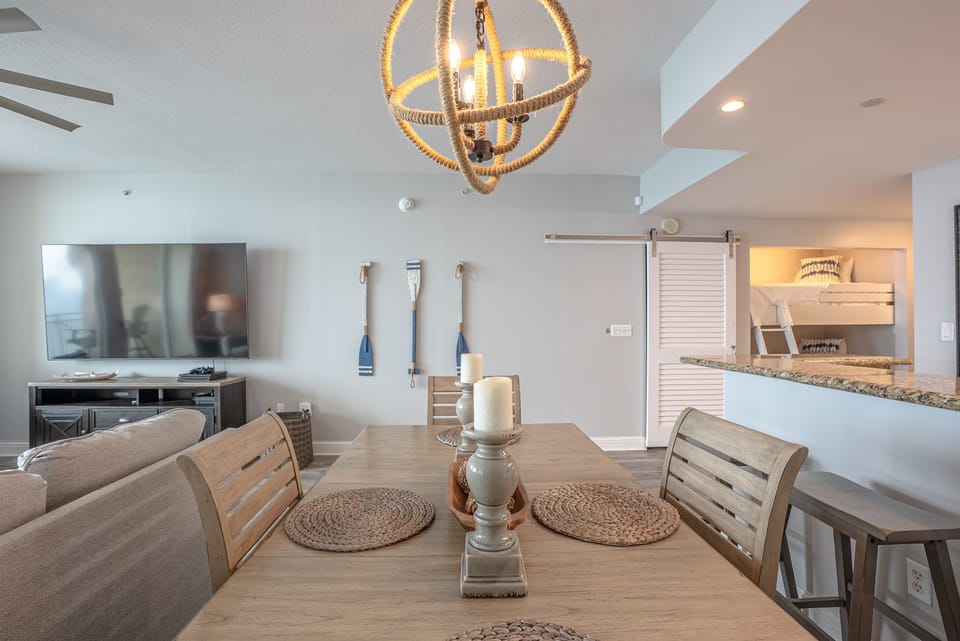 Table set for meals with a view into the living room and kitchen.
