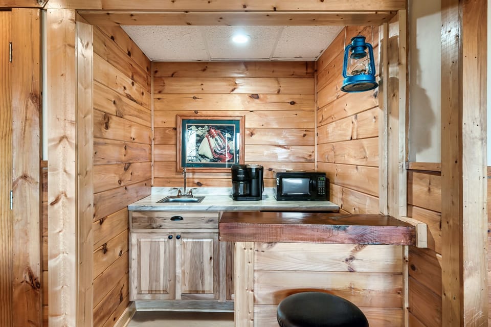 Kitchenette in the lower level family game room with a small fridge and microwave for drinks and popcorn on movie nights!