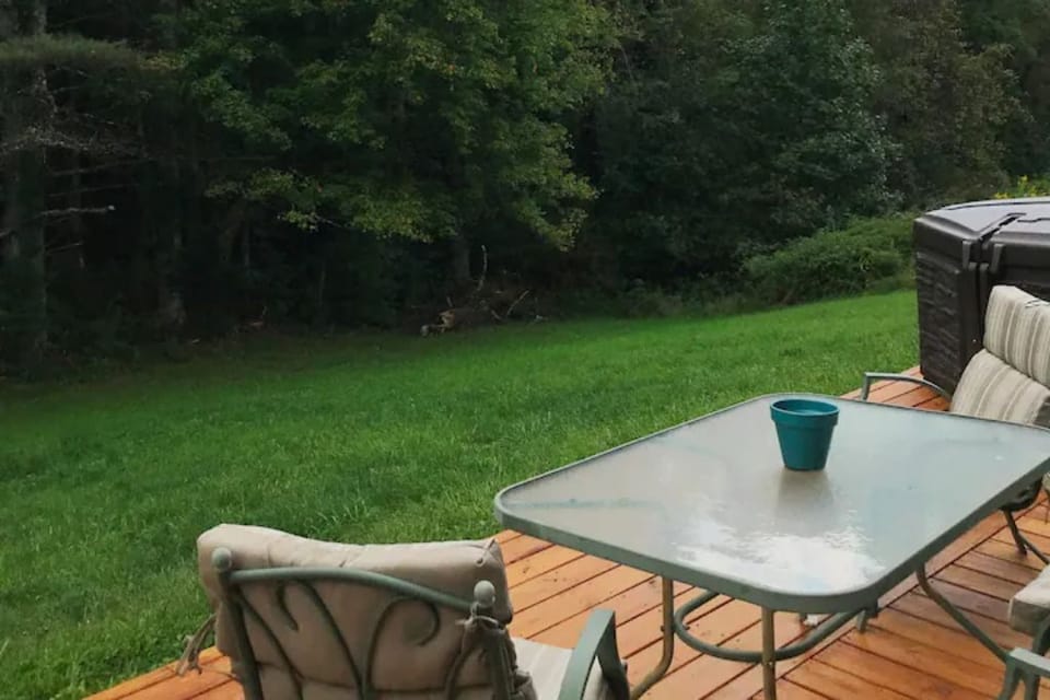 Back deck with patio furniture and hot tub