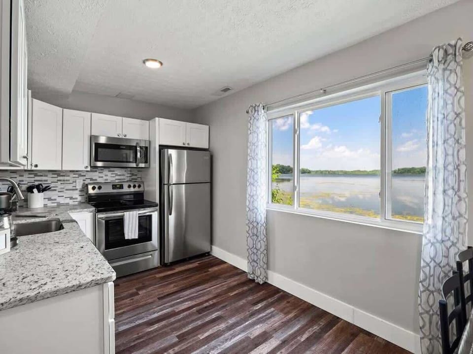 Cook in the modern kitchen while enjoying scenic lake views through the window