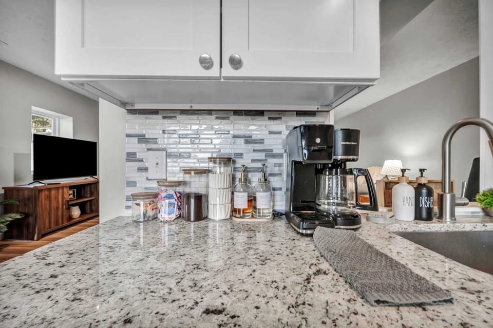 Well-equipped kitchen w/ granite counters, stainless appliances & ample storage.

