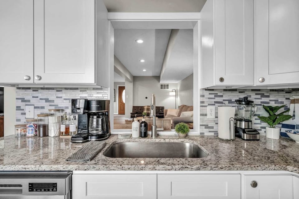 Chef-friendly kitchen w/ a large island, pendant lighting & open flow.
