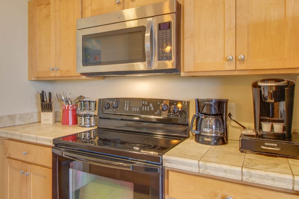 This kitchen features a standard coffee pot + single serve coffee maker!