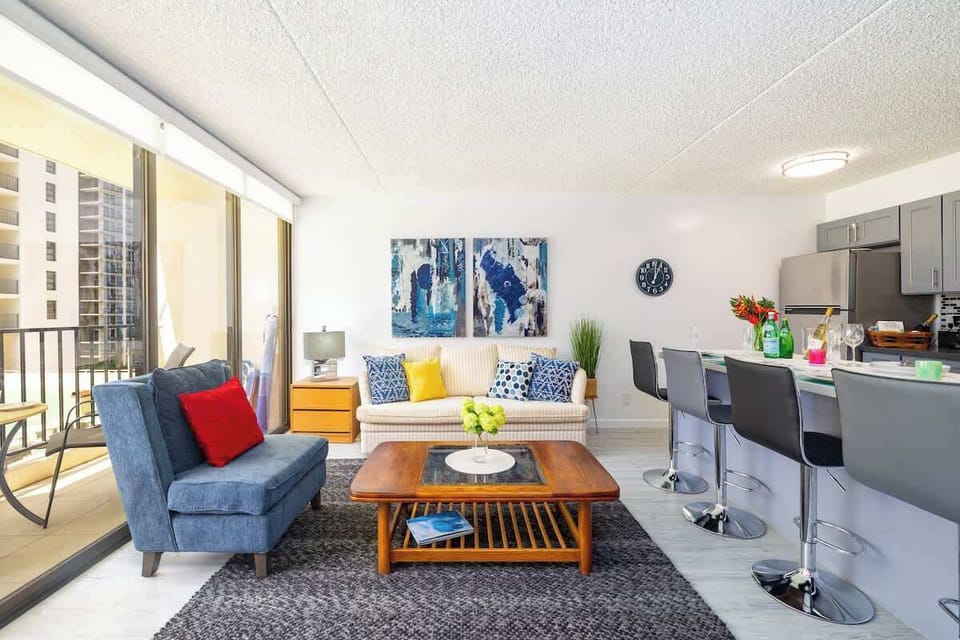 Living room with one armchair, pull-out sofa, and a countertop for dining up to 4 people.