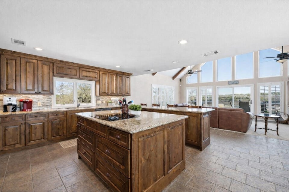 Make family meals easy in this large, fully stocked kitchen at Lakeshore Haven—your great experience in Spicewood, TX starts with Lake Travis views nearby.