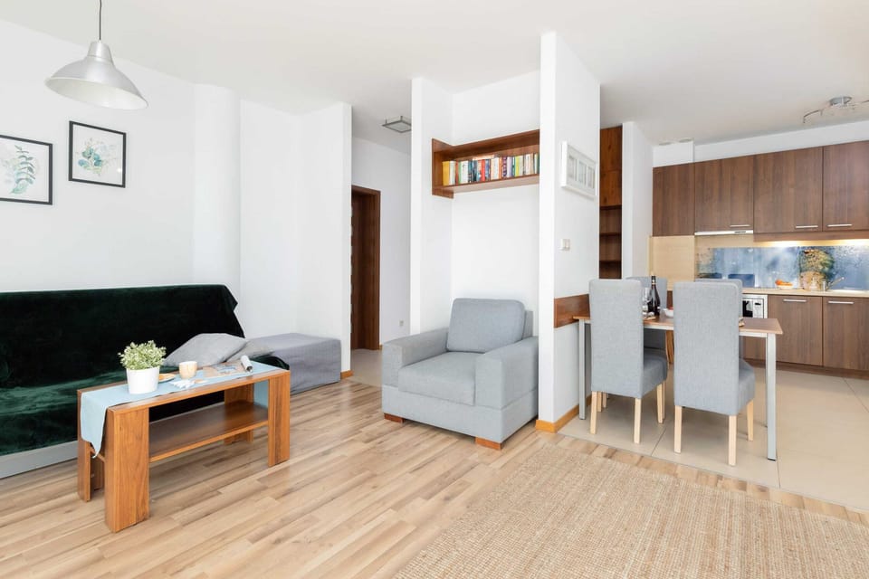 Open-plan living area with a sofa and dining space.
