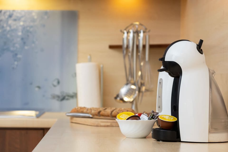Coffee corner featuring a coffee machine and mugs for a perfect start to the day.
