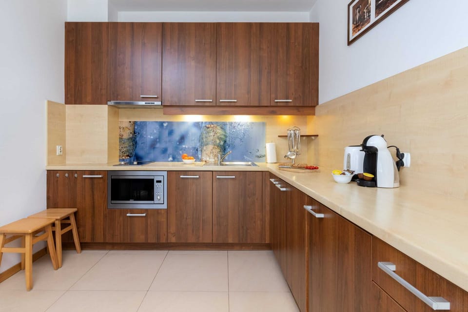 Fully equipped kitchen with wooden cabinets and a modern layout.
