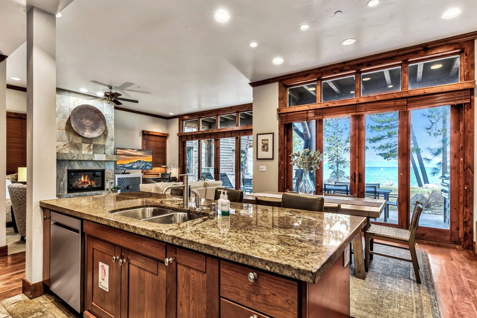 Gather around this gorgeous granite island while stunning lake views frame your culinary adventures through floor-to-ceiling windows.