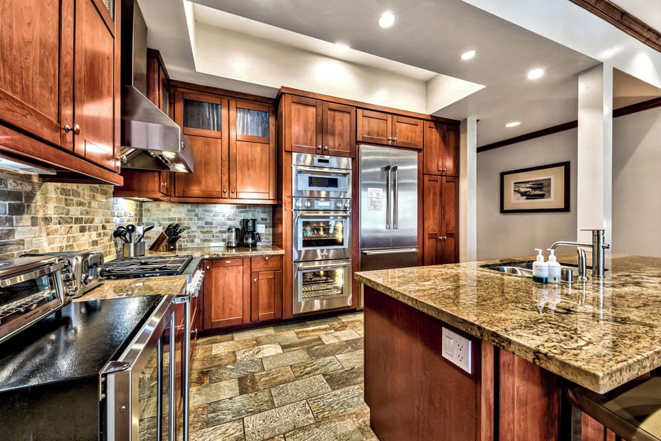The kitchen is equipped with top of the line stainless steel appliances