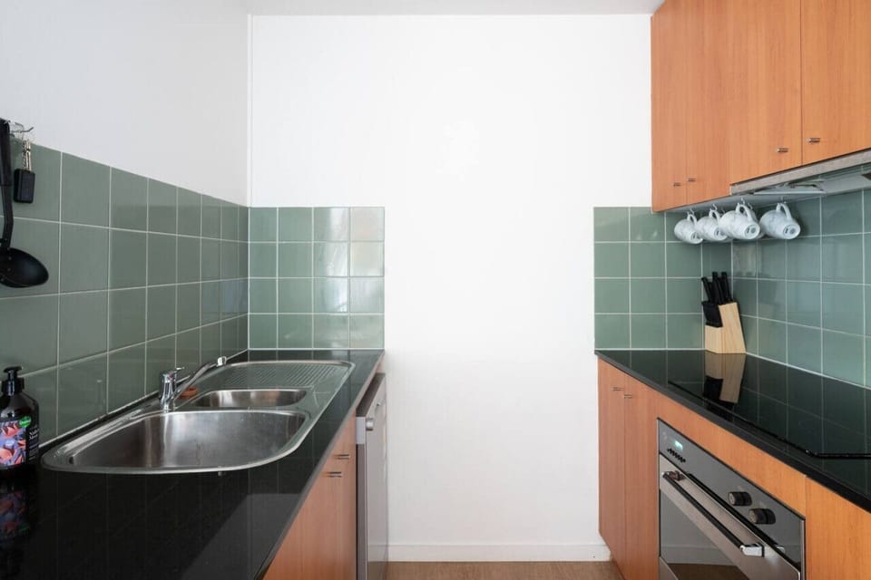 [Kitchen] Cleaned and spacious kitchen with wooden cabinets.