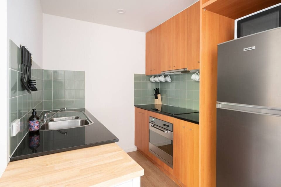 [Kitchen] Fully equipped kitchen with cooking appliances and plenty of cooking utensils for the times you just want to stay in.