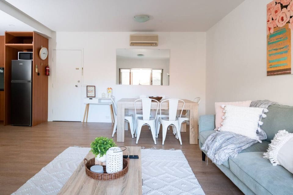 [Living Room] An open-plan living/lounge area leads to an air-conditioned dining area.