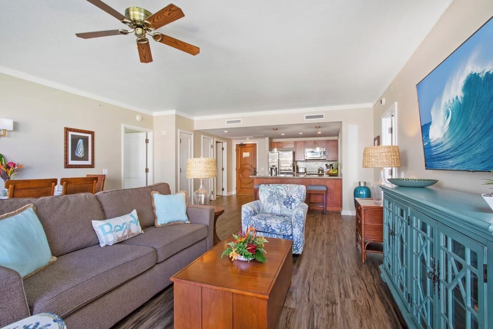 Stylish island-inspired living room with full kitchen and cozy comfort.