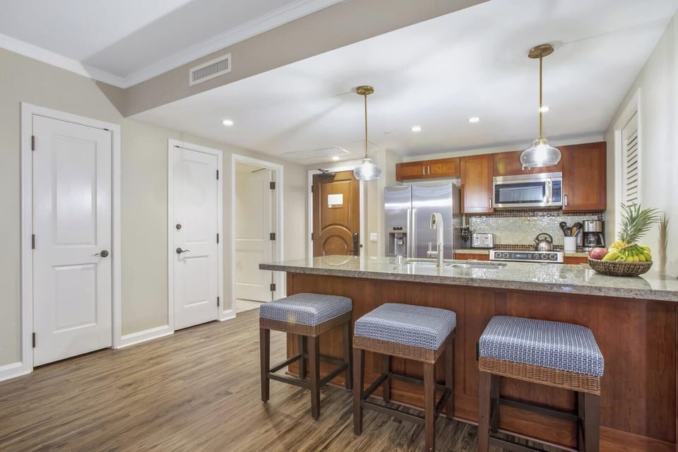 Sleek island kitchen with modern appliances and inviting breakfast seating.