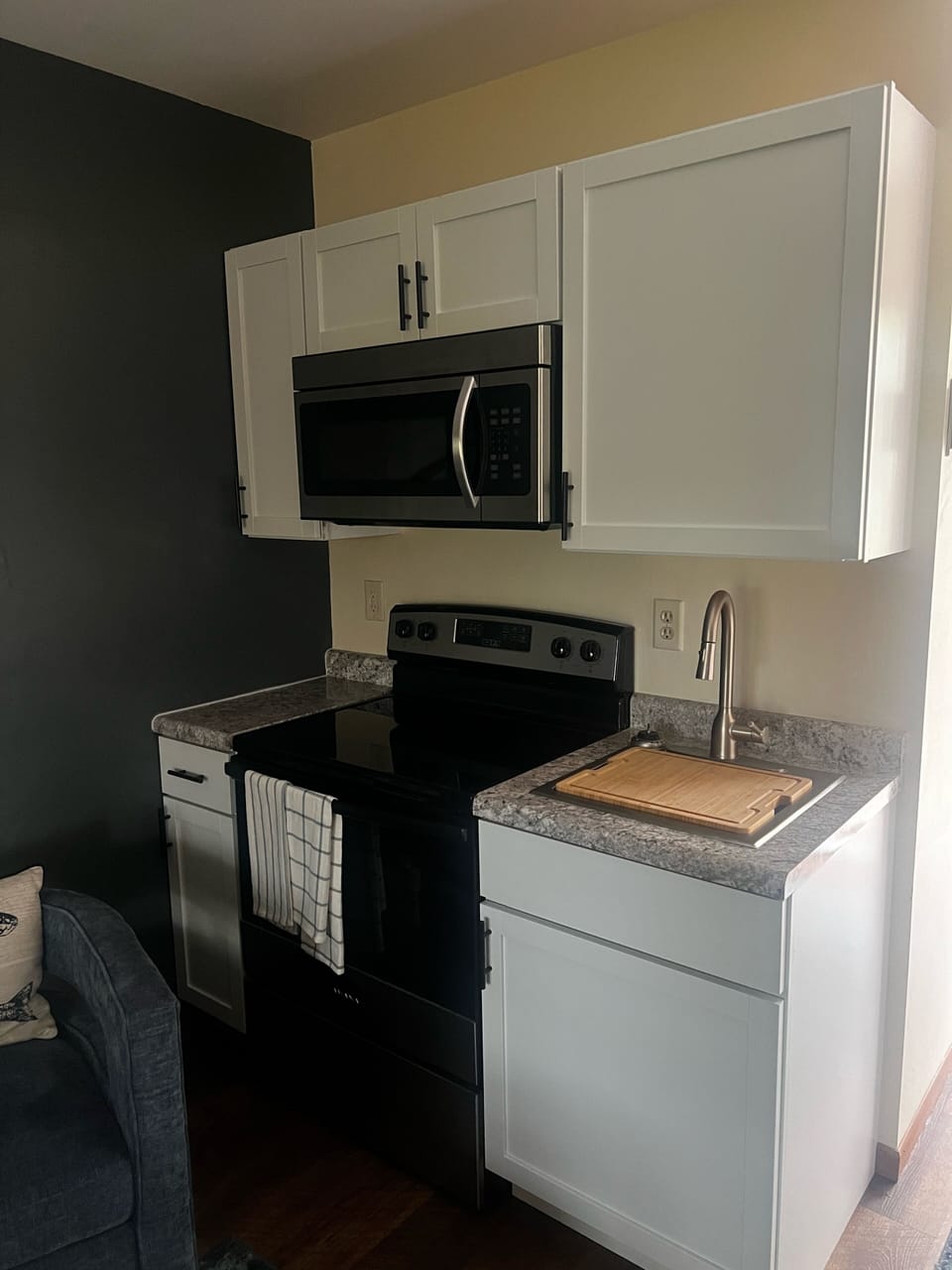 Full kitchen. Stove, oven, microwave, sink, utensils, dinnerware available.