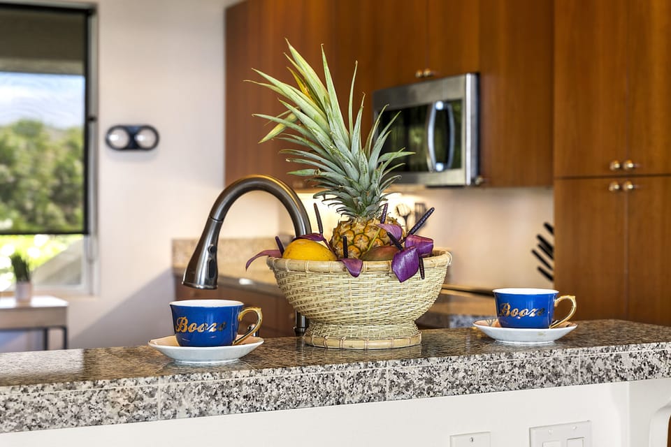 Full kitchen with breakfast bar, granite counters, and stainless steel appliances