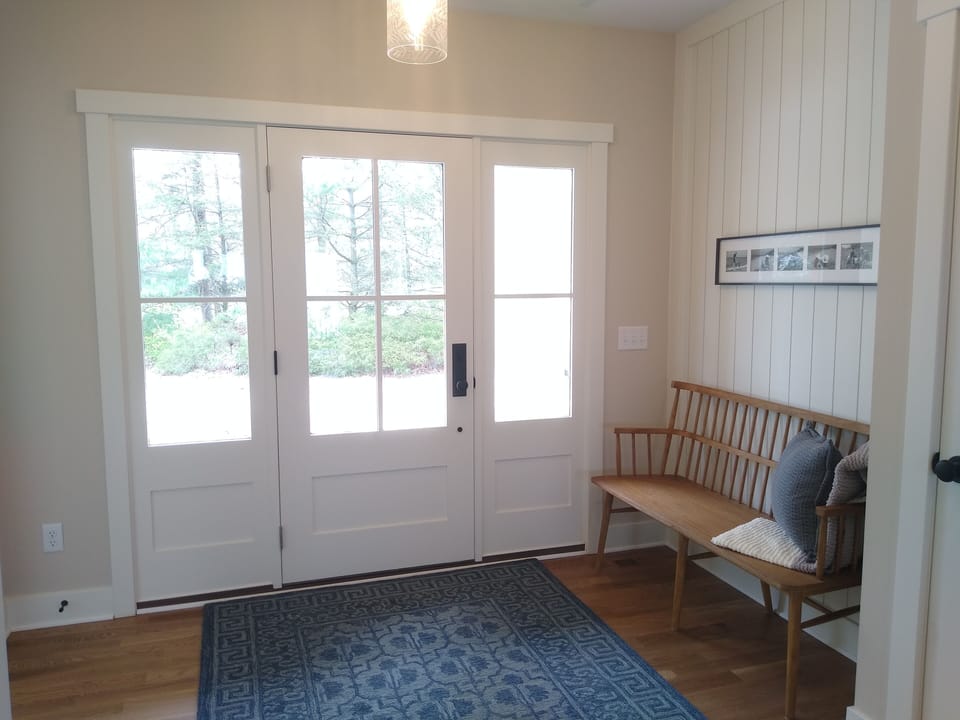 Welcoming Front Entry with PB Pendant Lights Set in Shiplap Coffer