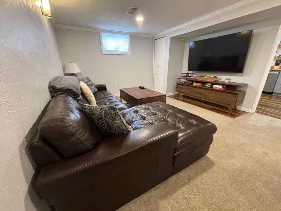 Soft leather couch and large screen (65") smart tv in main living space