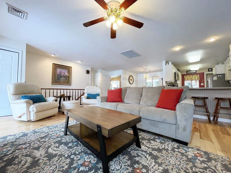 The home offers spacious living areas on both floors, with 3 bedrooms on each level, providing privacy and comfort for all guests. This is the upstairs living room.