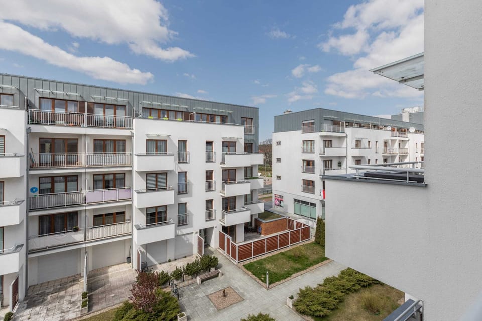 Exterior view of a residential building with modern architecture and open balconies.
