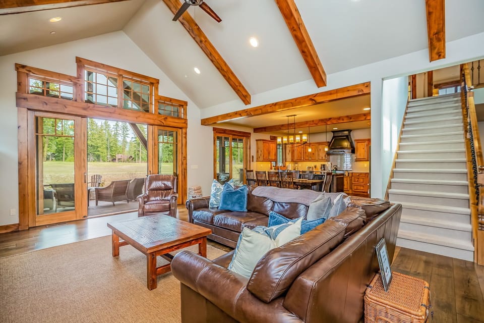Elegant open-concept space with cozy living, formal dining, and luxe lodge flair
