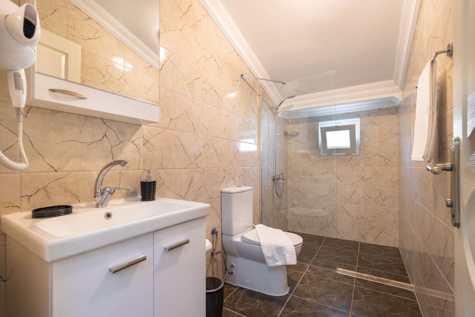 Shower, rainfall showerhead, hair dryer, towels