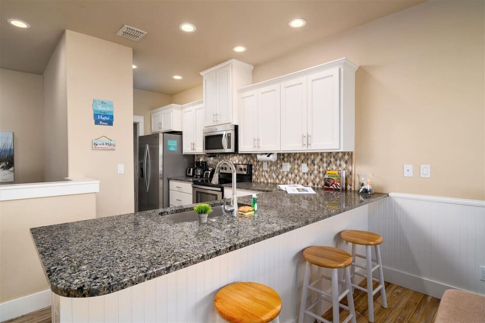 Kitchen with bar—ideal for sipping, snacking, and relaxing.