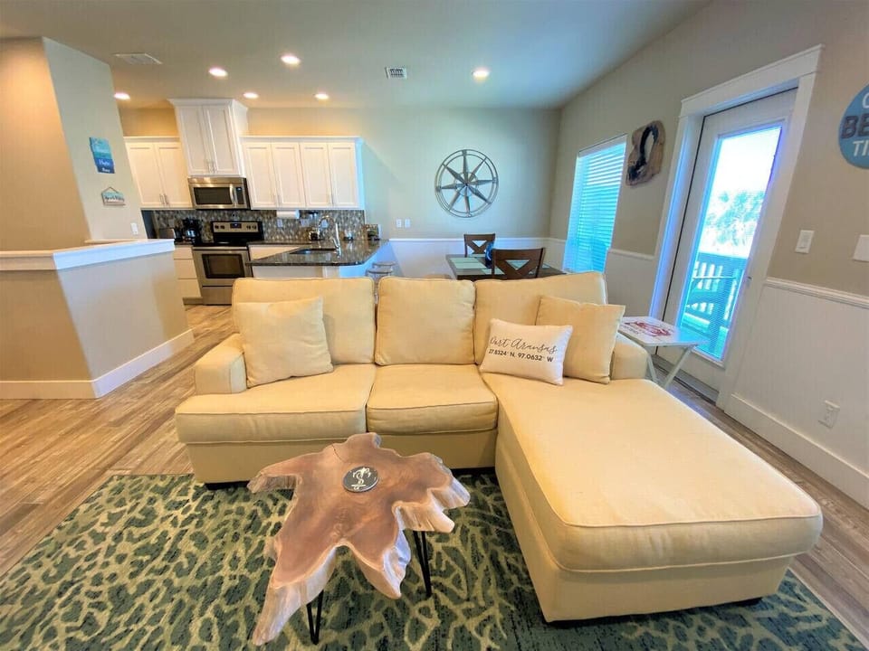 Kick back on a cozy couch in the airy, laid-back living room.
