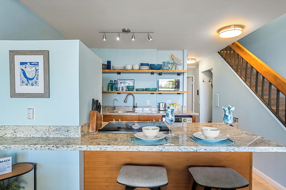 Modern kitchen with granite island and bar seating for two.