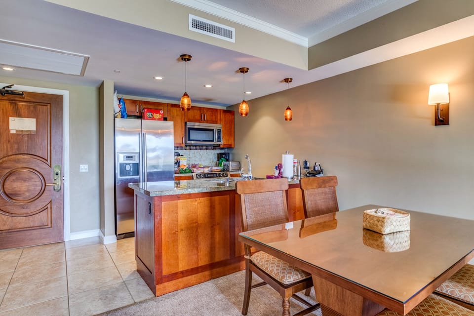 Entry & full kitchen including kitchen island, dining table and 4 chairs.