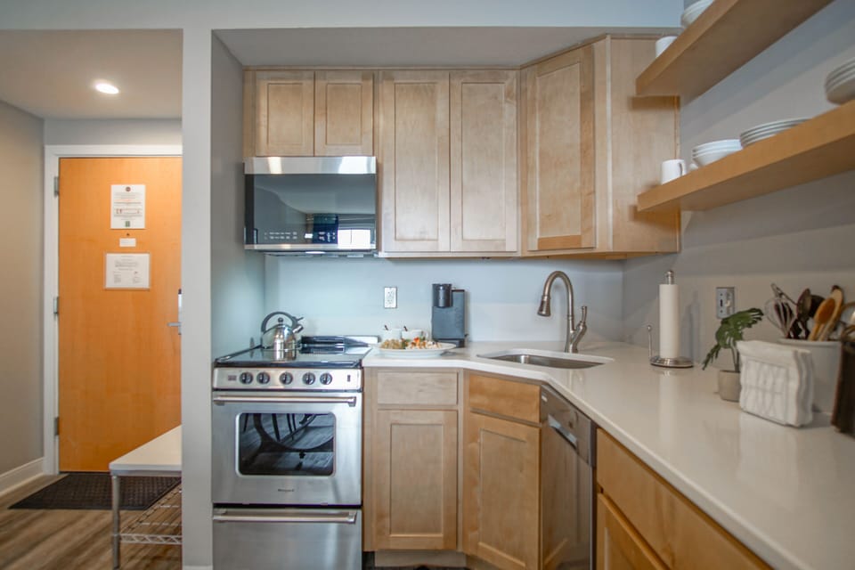 The fully equipped kitchen features modern appliances, generous counter space, and all the essentials needed for effortless cooking and dining.