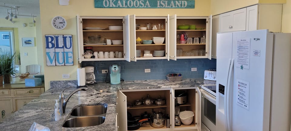 Kitchen with stocked kitchenware.