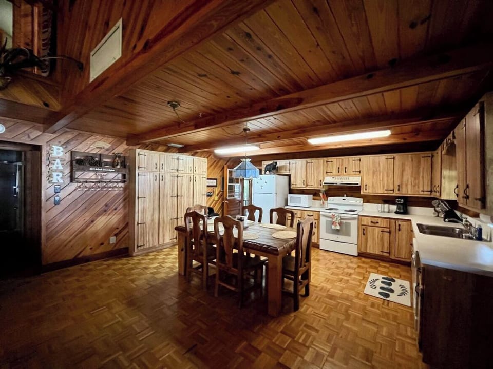 Full kitchen with fridge, oven, stovetop, microwave, coffeemaker, & dishwasher.