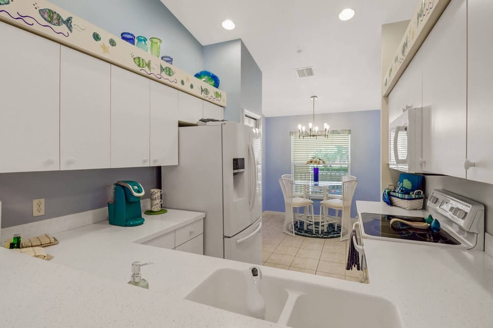 The kitchen includes a full size refrigerator/freezer, oven, microwave and dishwasher.