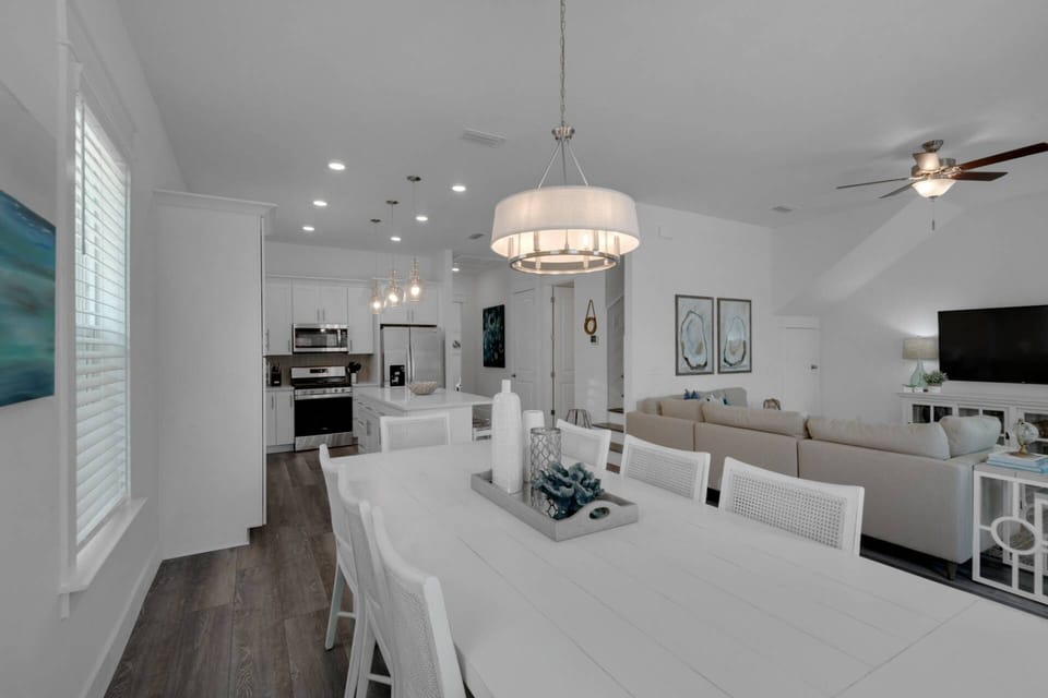 Large dining room area with seating for 8 and additional seating at the island for 4