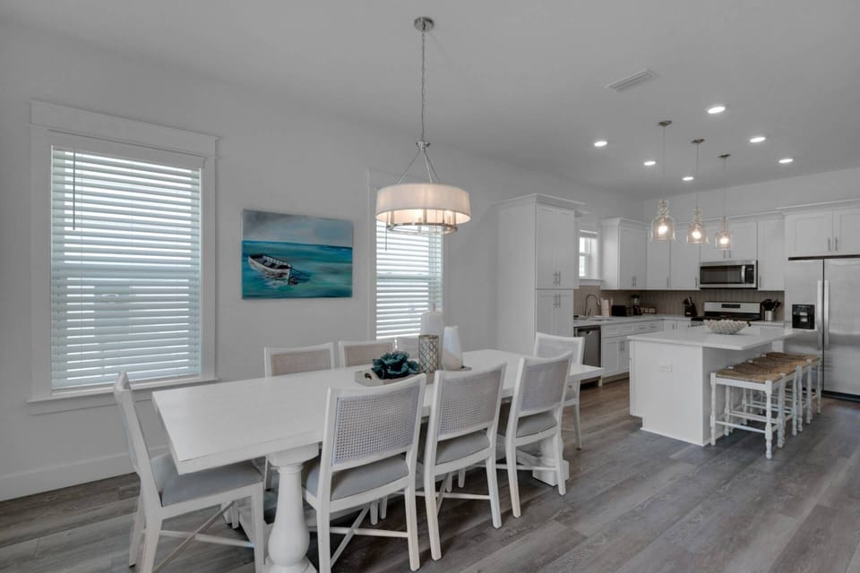 Large dining room area with seating for 8 and additional seating at the island for 4