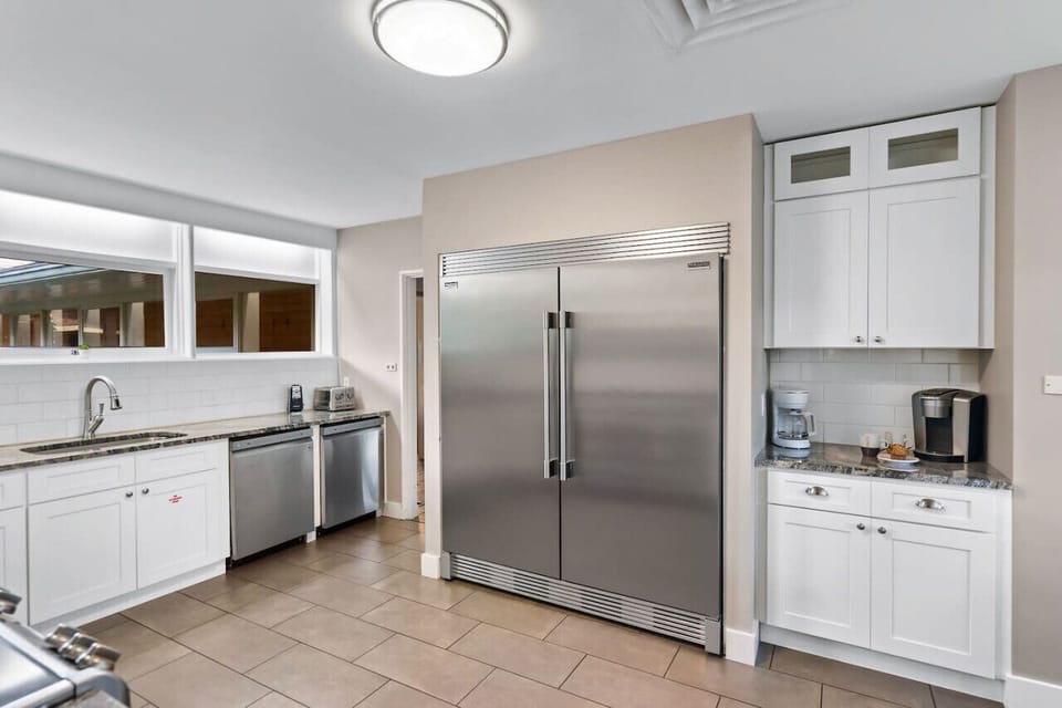 Large kitchen with 2 stoves and large refrigerator/freezer