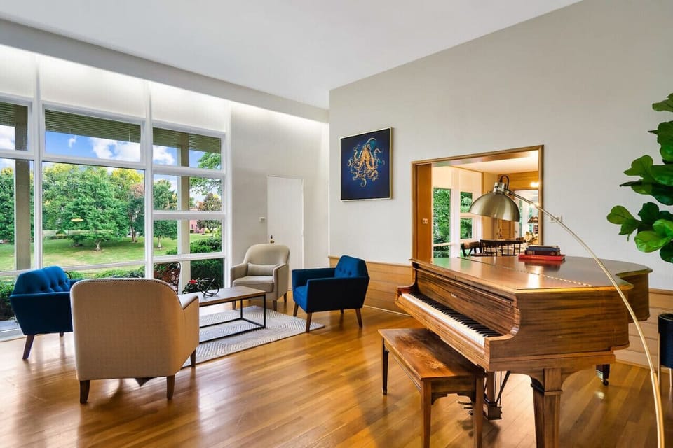 Living room with fireplace and piano