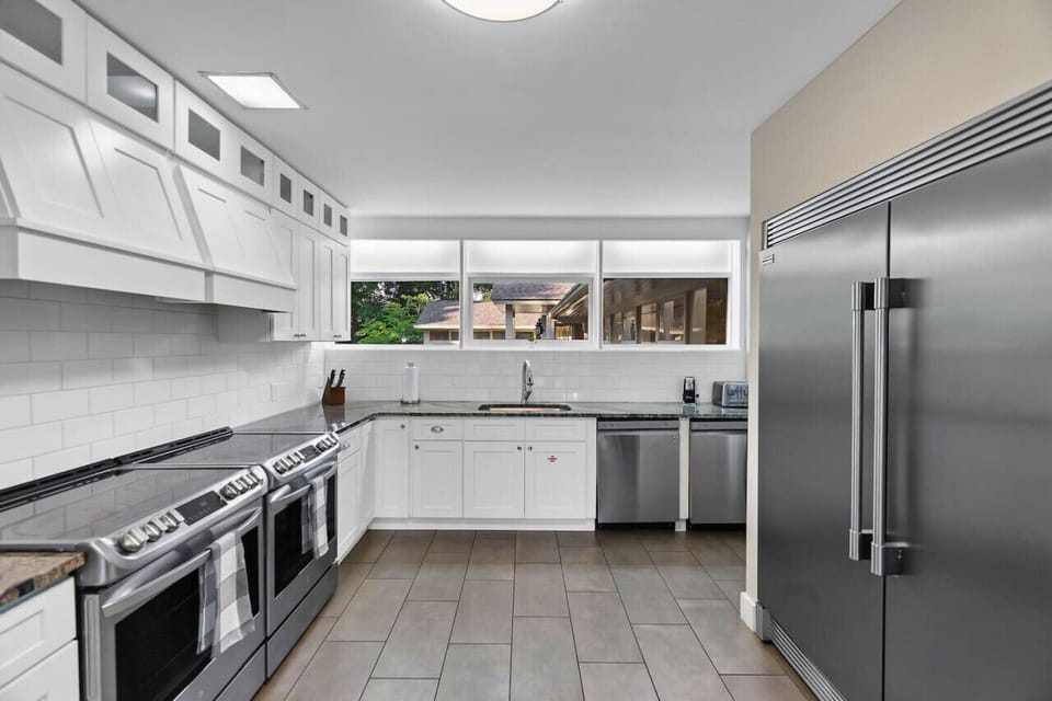 Large kitchen with 2 stoves and large refrigerator/freezer